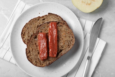 Photo of Sandwich with quince paste on light grey marble table, flat lay