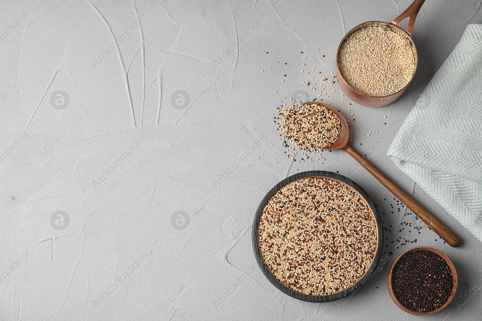 Photo of Flat lay composition with different types of quinoa and space for text on grey background