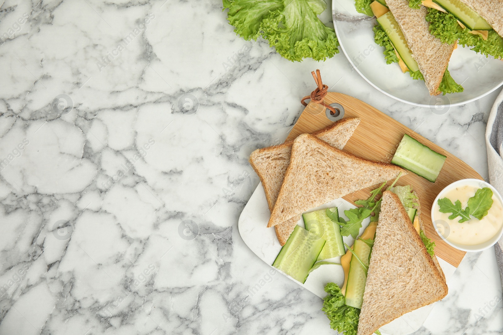 Photo of Flat lay composition with tasty sandwich and ingredients on white marble table. Space for text