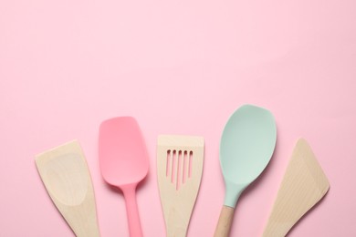 Photo of Different spatulas on pink background, flat lay. Space for text