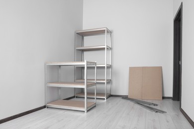 Photo of Office room with white walls and metal storage shelves
