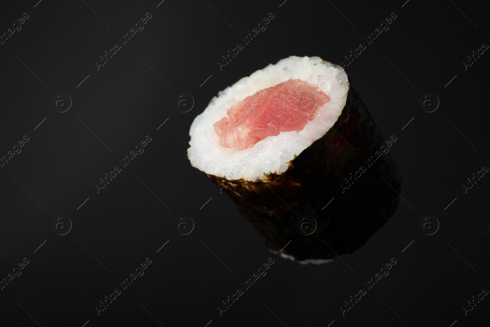 Photo of Sushi roll with tuna on black background