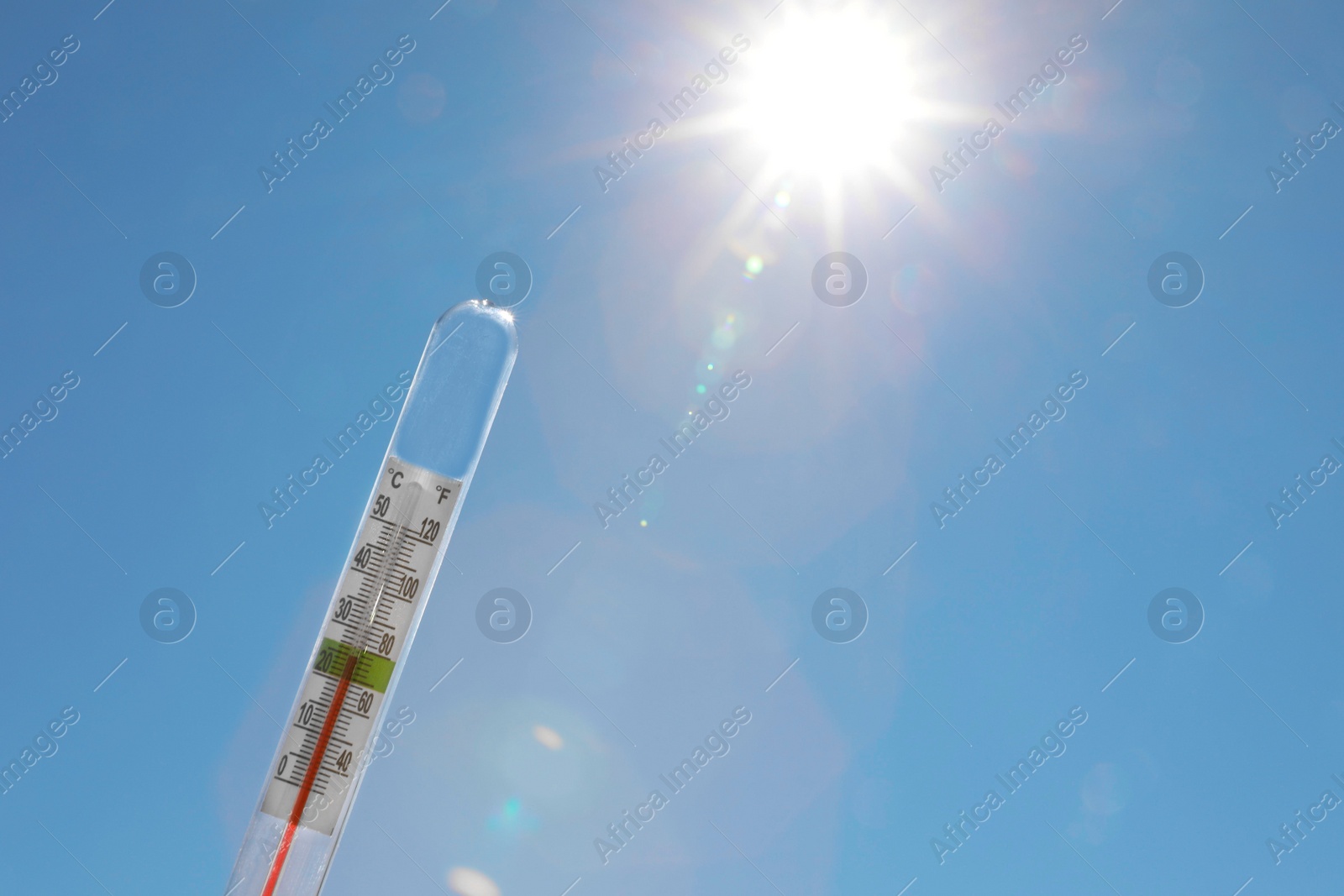 Photo of Weather thermometer against blue sky, space for text
