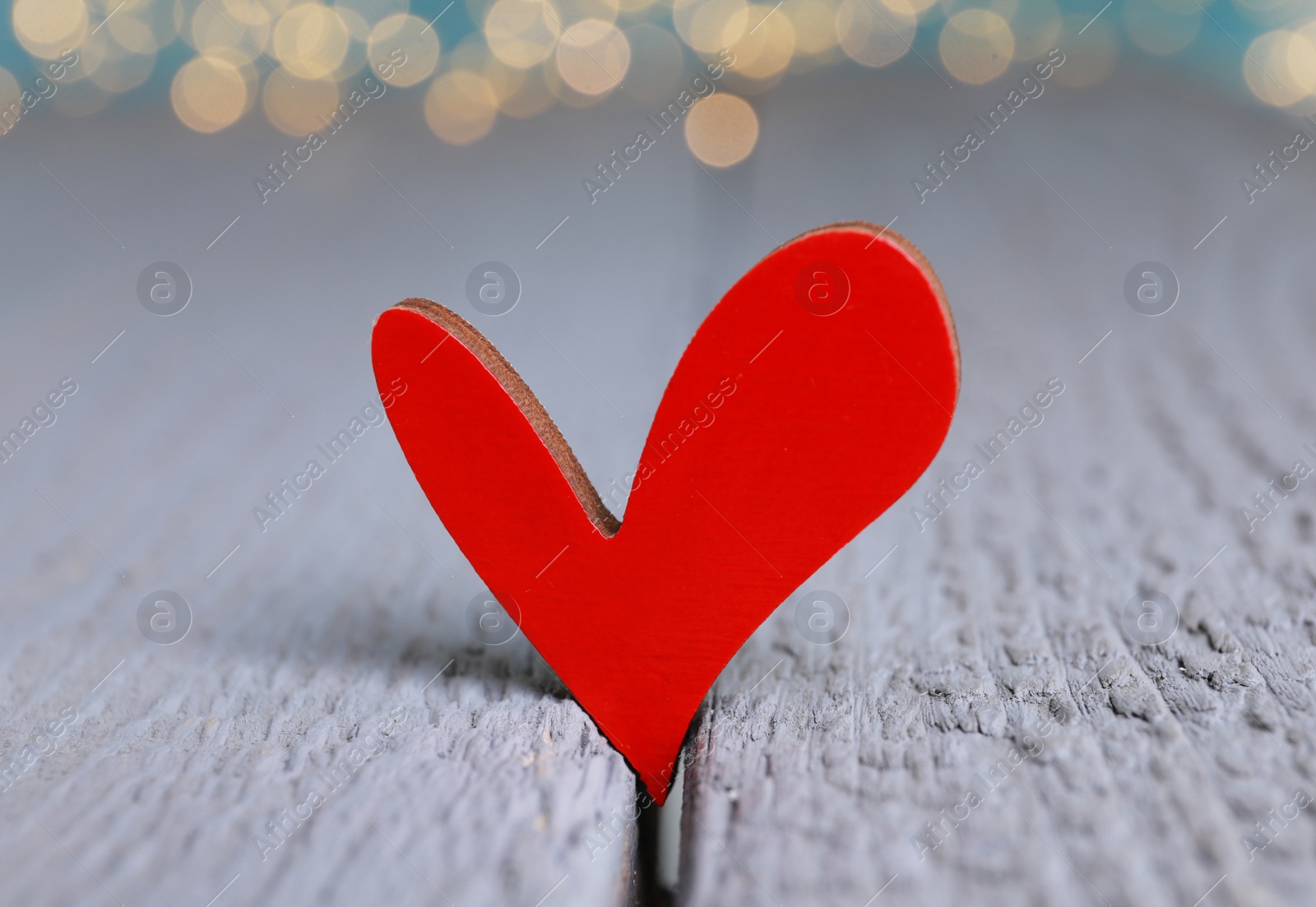 Photo of Red decorative heart on grey wooden table, closeup