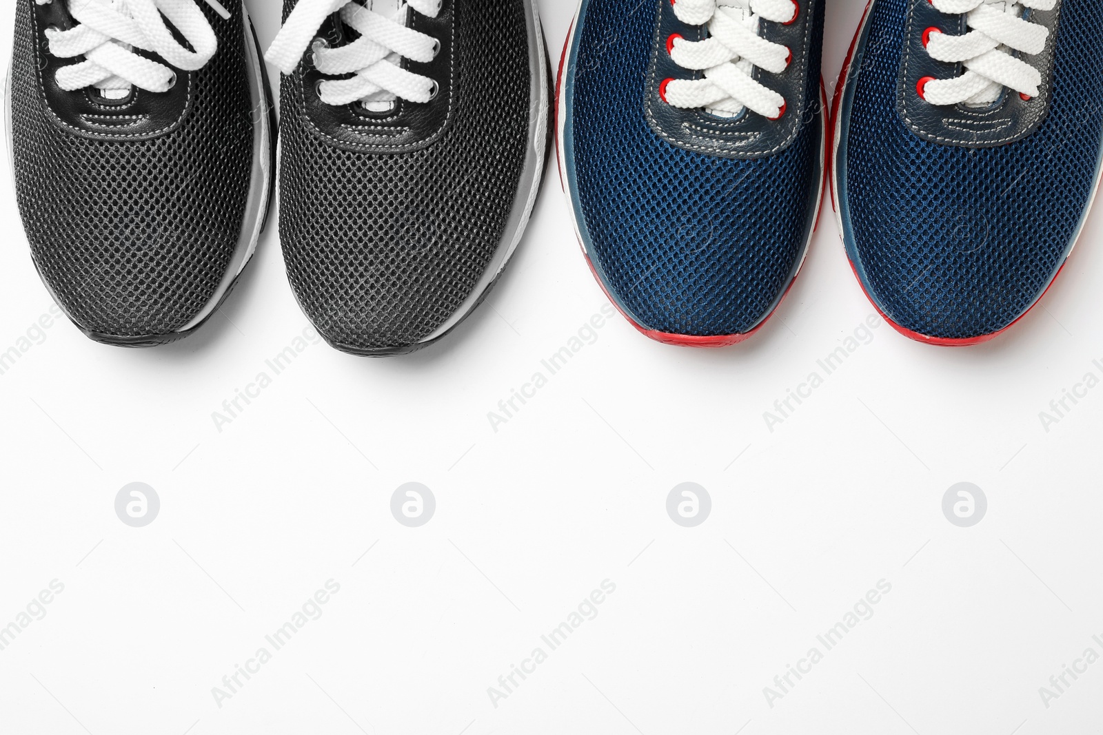 Photo of Flat lay composition of stylish training shoes on white background