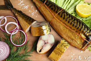 Photo of Flat lay composition with smoked fish on wooden table