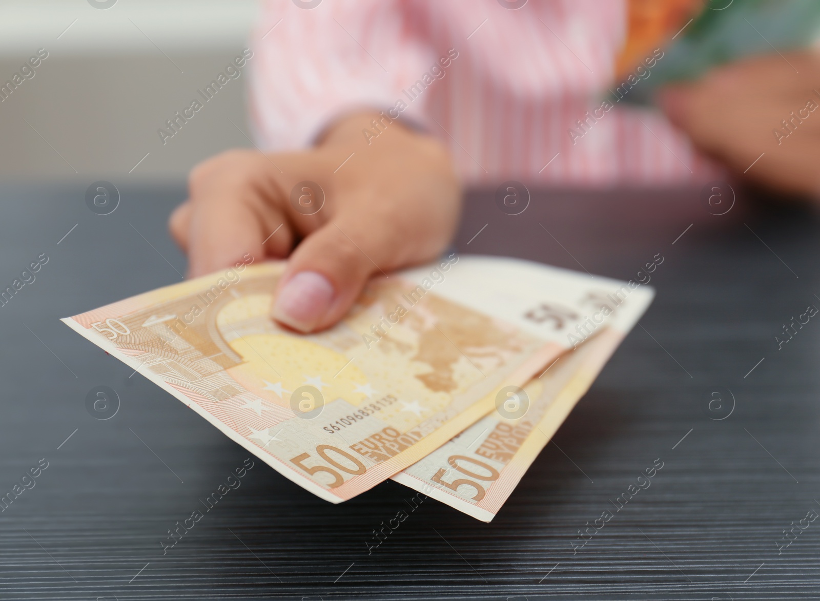 Photo of Woman with Euro banknotes at table indoors, closeup