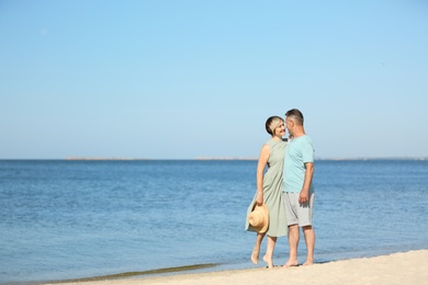 Photo of Happy mature couple at beach on sunny day