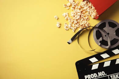 Photo of Flat lay composition with popcorn and space for text on color background. Cinema snack