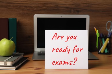 Photo of Card with question Are You Ready For Exams? on wooden table