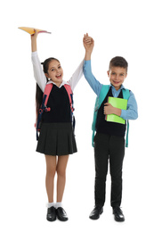 Photo of Happy children with school stationery on white background