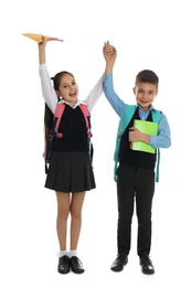 Happy children with school stationery on white background