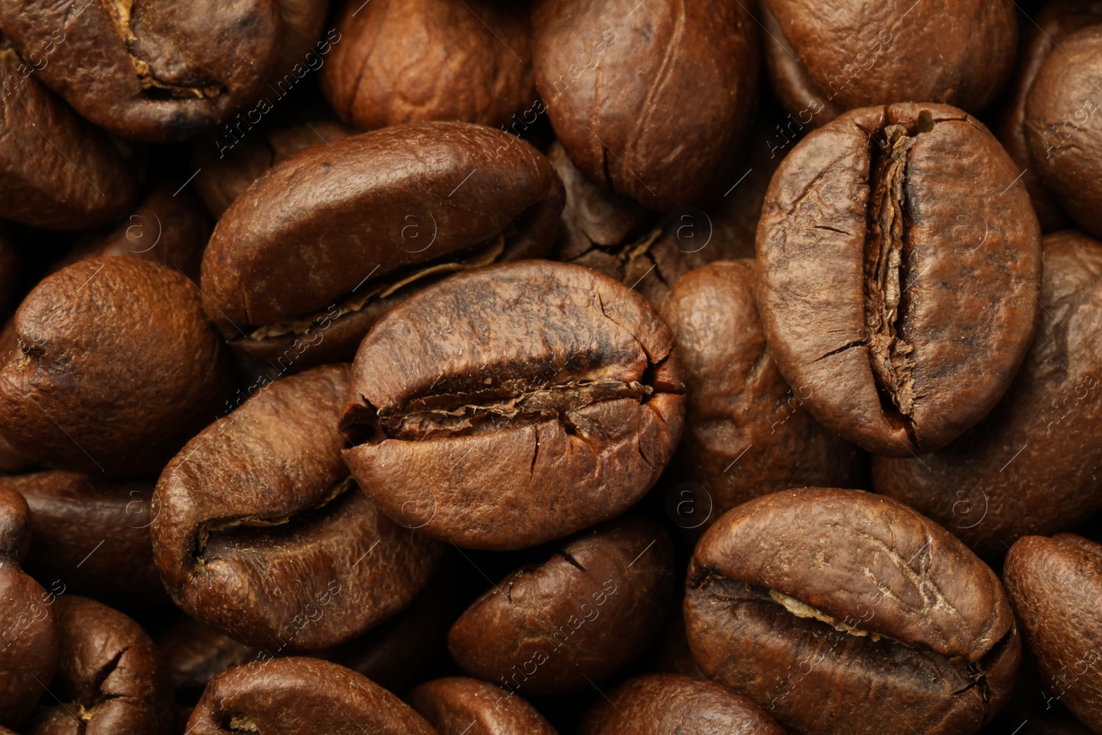 Photo of Pile of roasted coffee beans as background, closeup