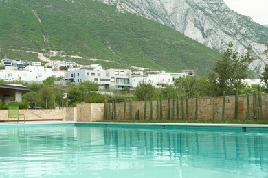 Photo of Outdoor swimming pool and beautiful mountain on background