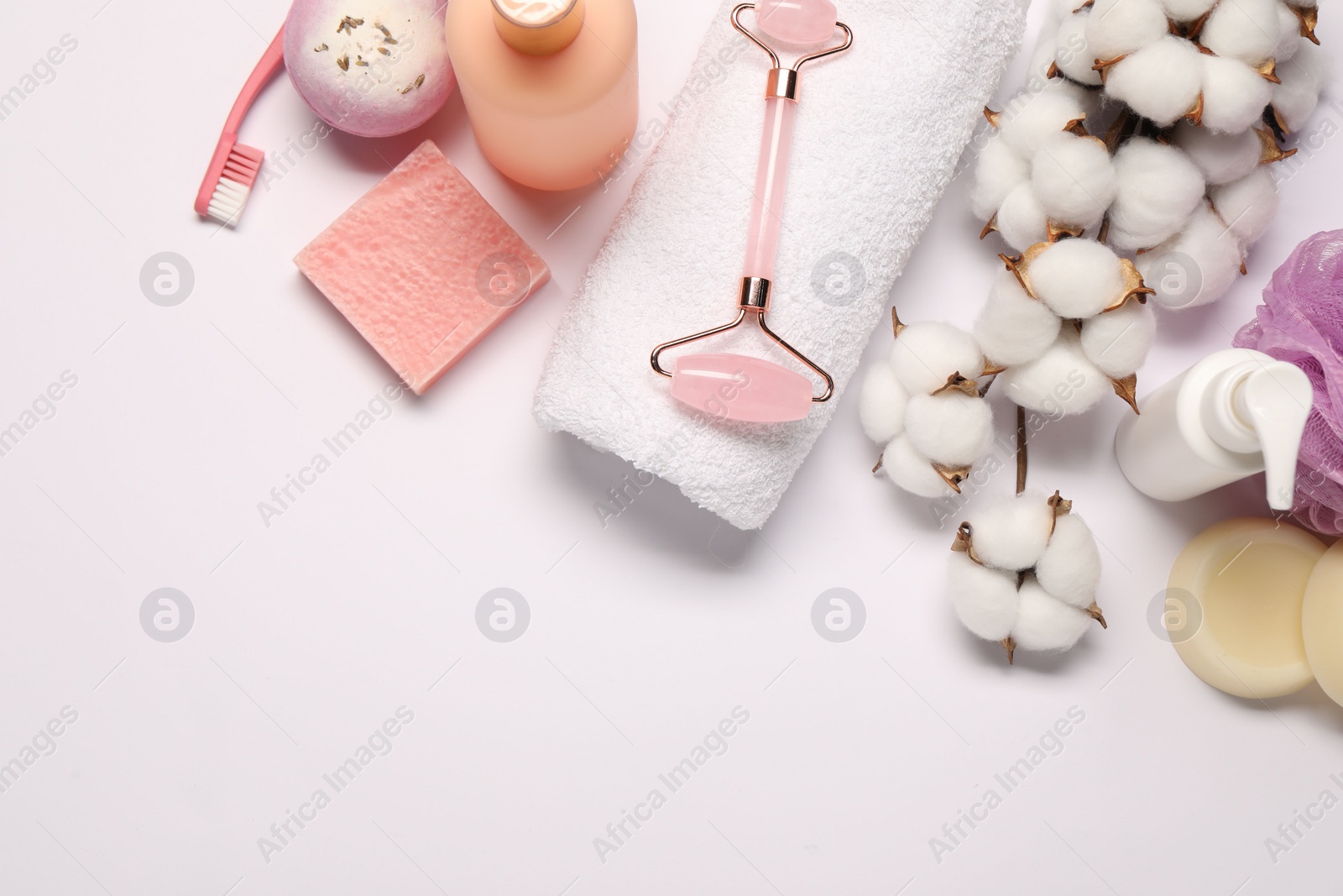 Photo of Bath accessories. Different personal care products and cotton flowers on white background, flat lay with space for text