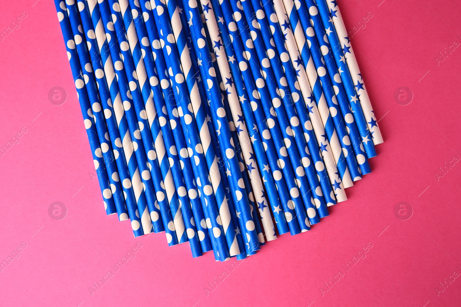 Photo of Many paper drinking straws on pink background, flat lay
