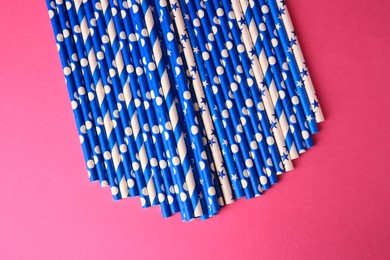 Many paper drinking straws on pink background, flat lay