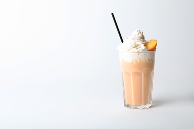Photo of Glass with delicious milk shake on white background