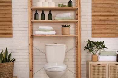 Photo of Stylish bathroom interior with toilet bowl and other essentials