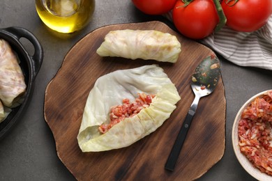 Ingredients for preparing stuffed cabbage rolls on grey table, flat lay