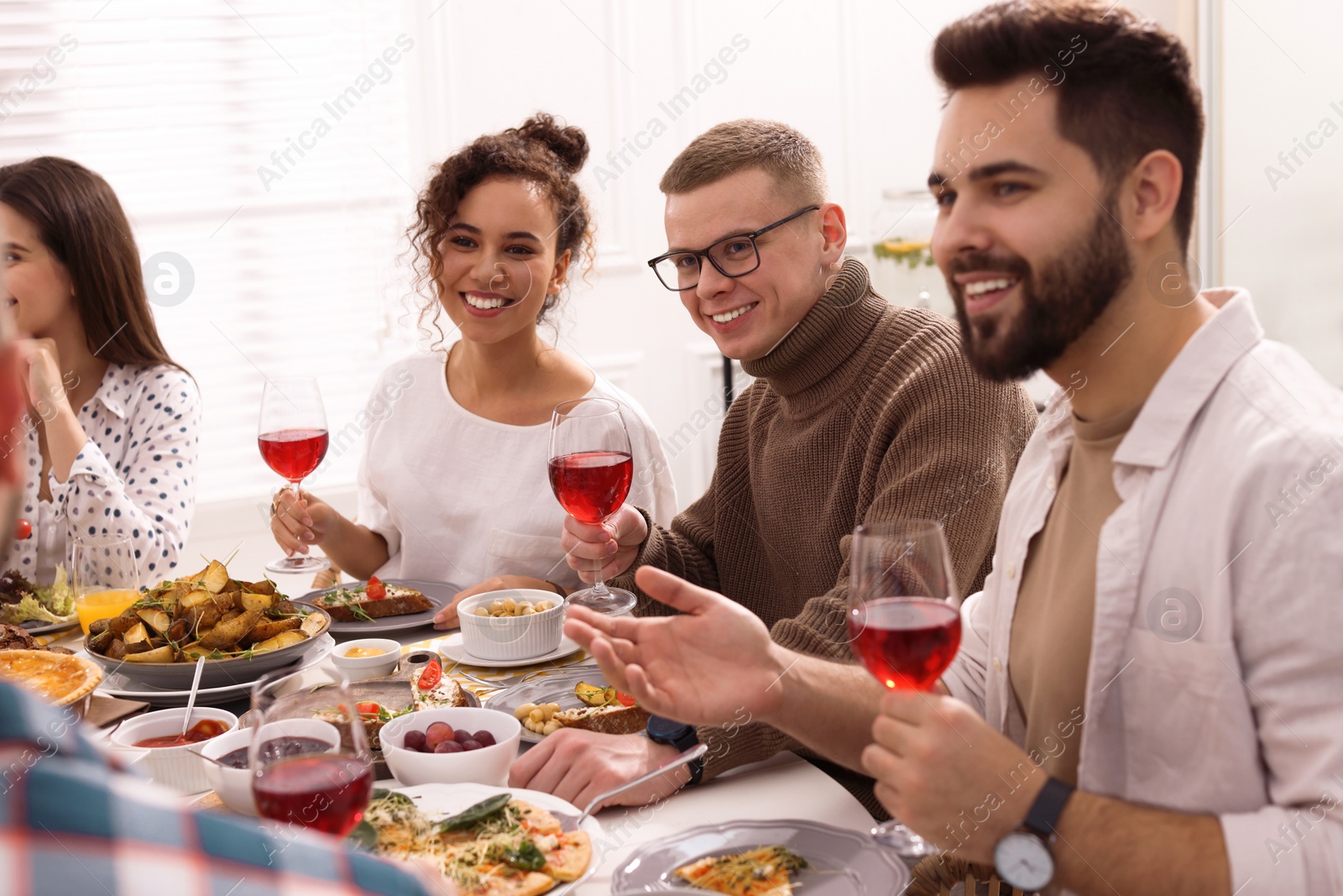 Photo of Group of people having brunch together at table indoors