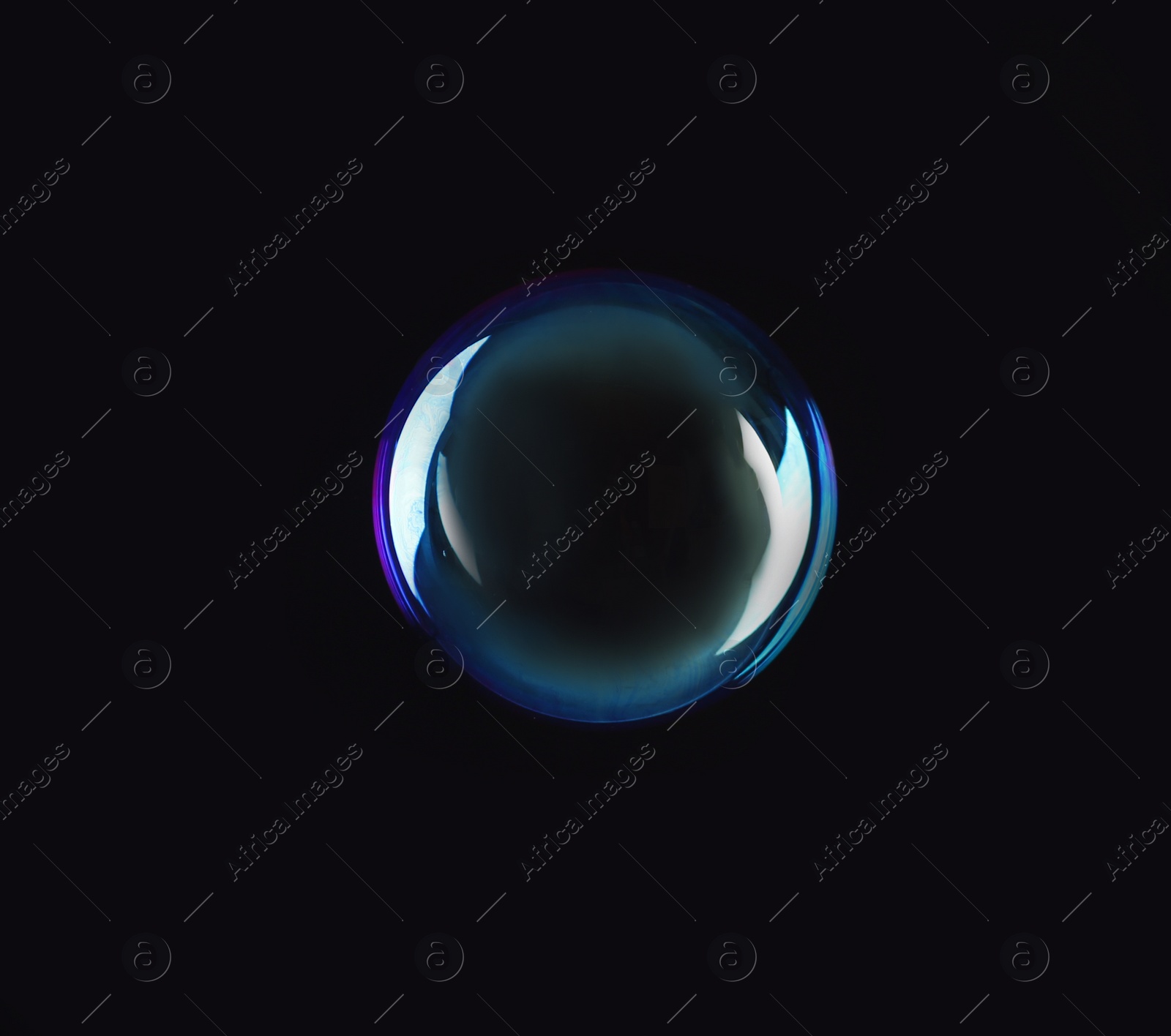 Photo of Beautiful translucent soap bubble on dark background