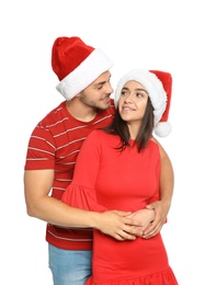 Photo of Young happy couple with Santa hats on white background. Christmas celebration