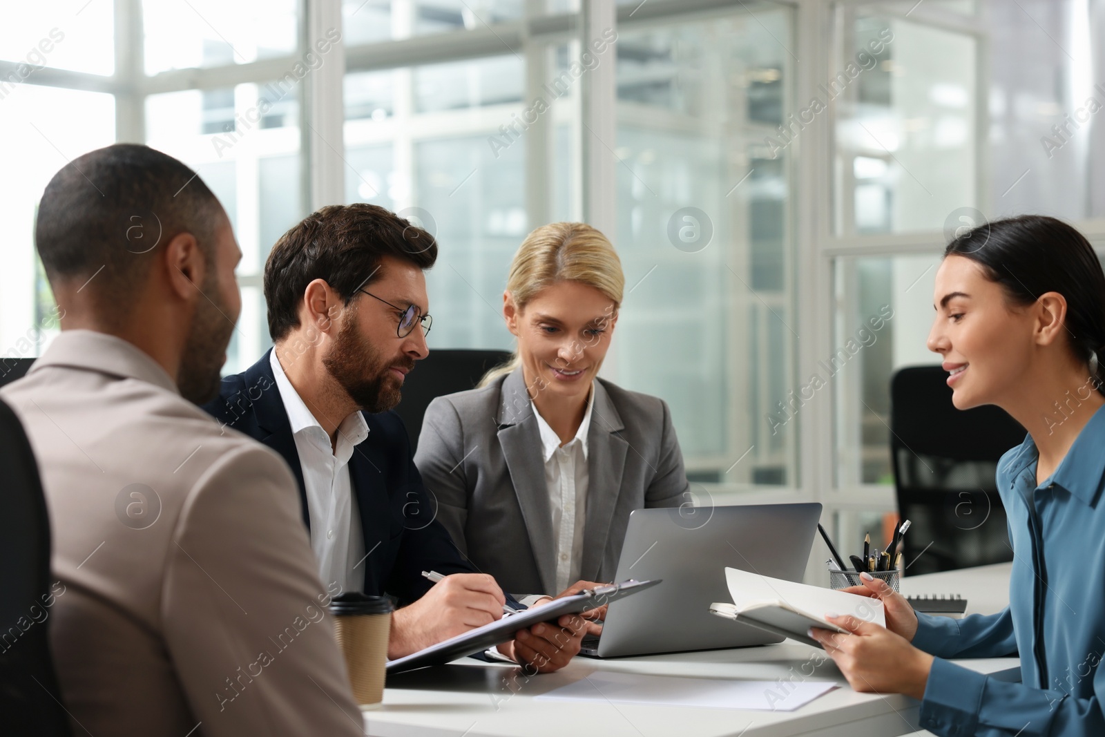 Photo of Lawyers working together at table in office