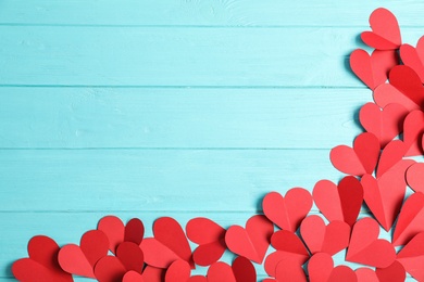 Photo of Flat lay composition with paper hearts and space for text on wooden background