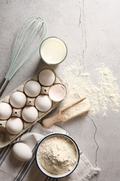 Photo of Making dough. Flour, eggs, milk and tools on light textured table, flat lay