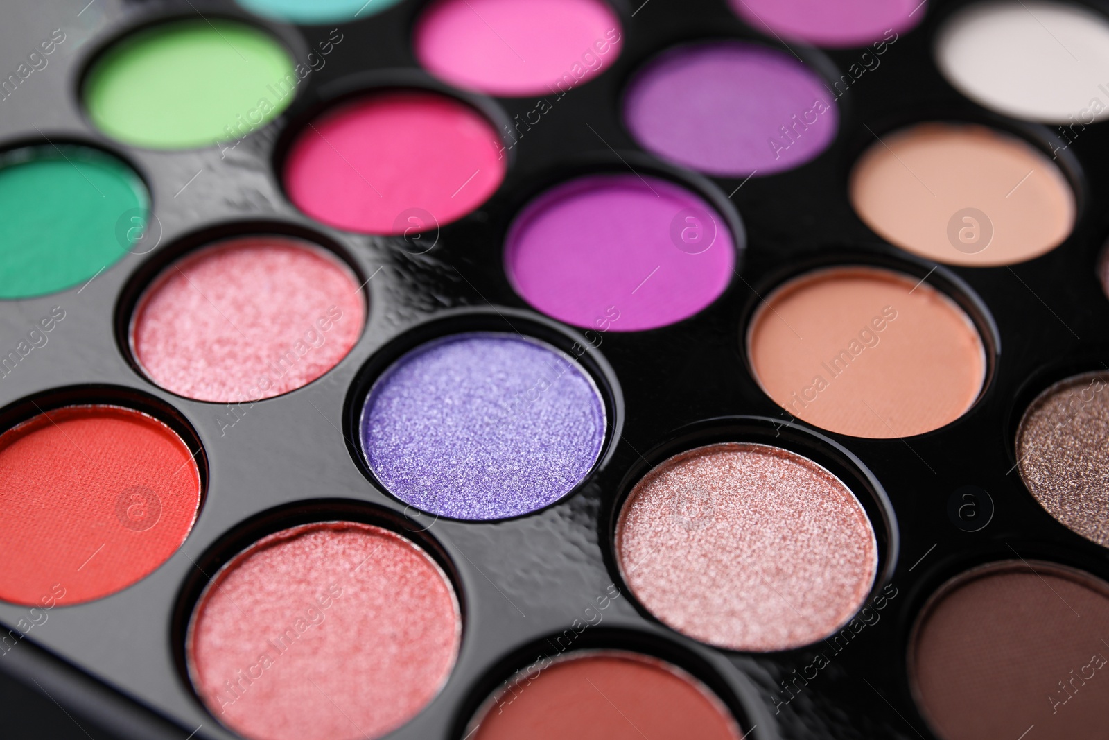 Photo of Beautiful eyeshadow palette as background, closeup. Professional cosmetic product