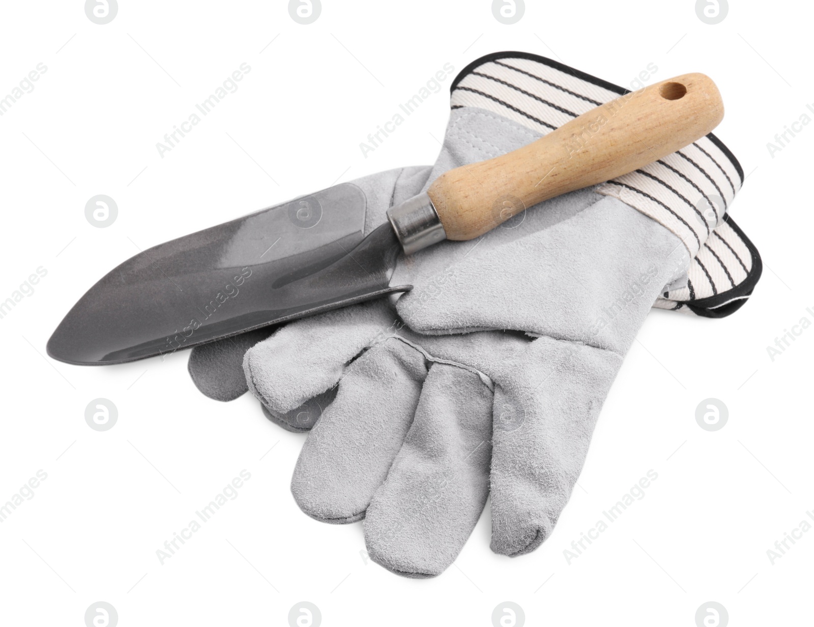 Photo of Gardening gloves and trowel isolated on white