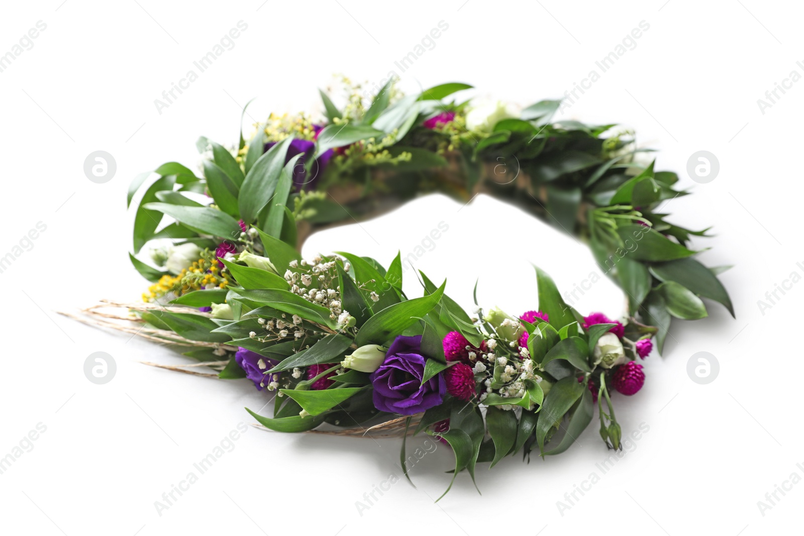 Photo of Beautiful wreath made of flowers and leaves on white table