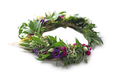 Beautiful wreath made of flowers and leaves on white table