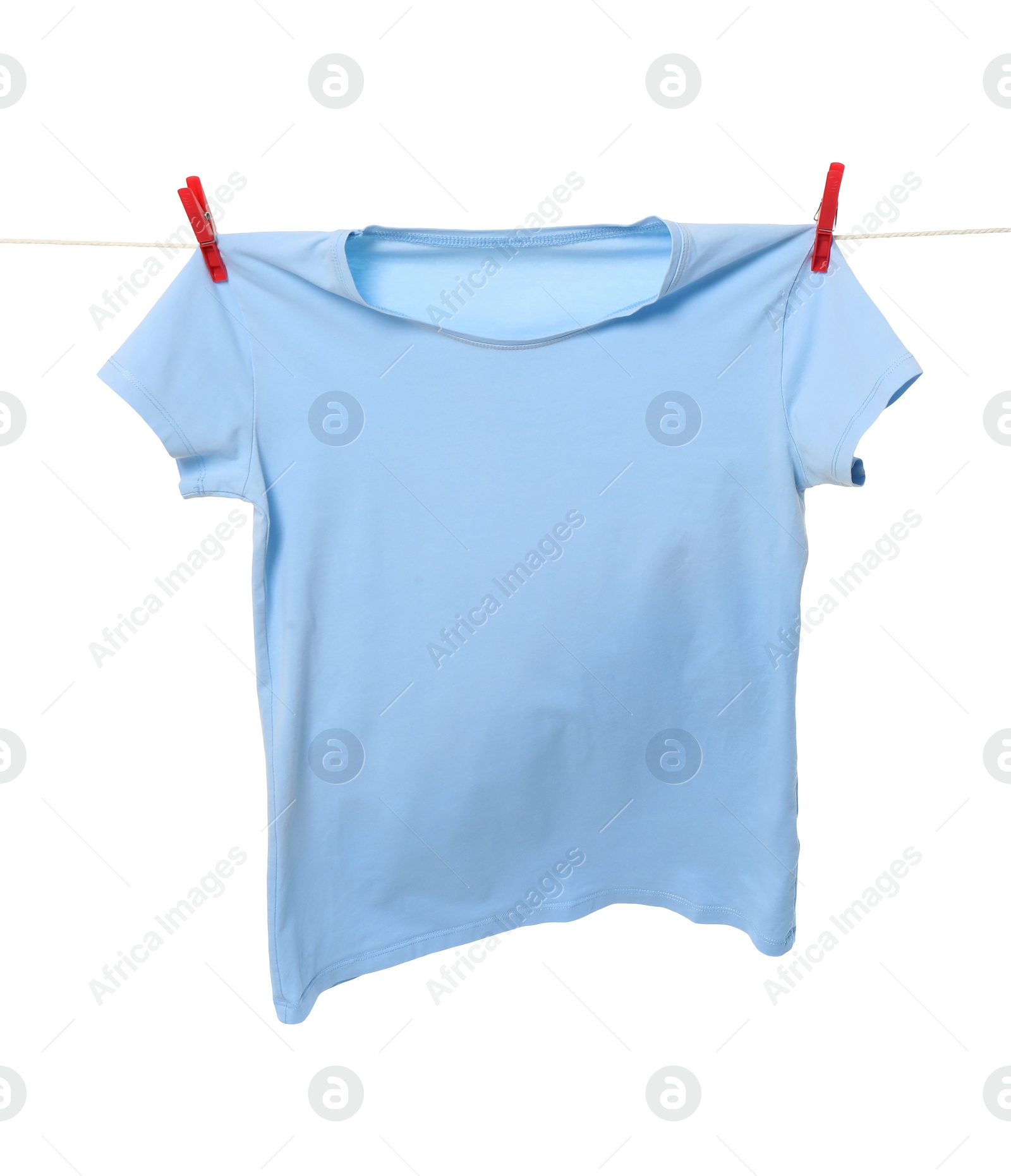 Photo of One light blue t-shirt drying on washing line isolated on white