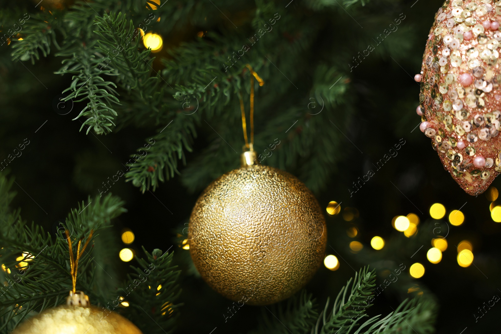 Photo of Beautiful Christmas balls hanging on fir tree, closeup