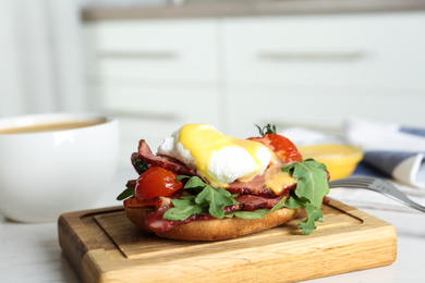 Delicious egg Benedict served on wooden board