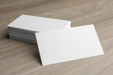 Blank business cards on wooden table. Mockup for design