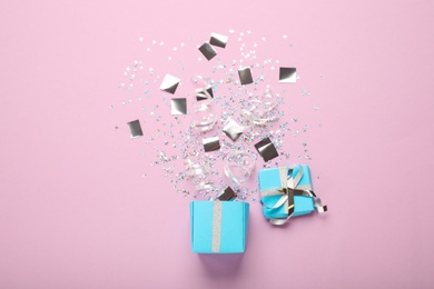 Photo of Flat lay composition with shiny confetti and box on pink background