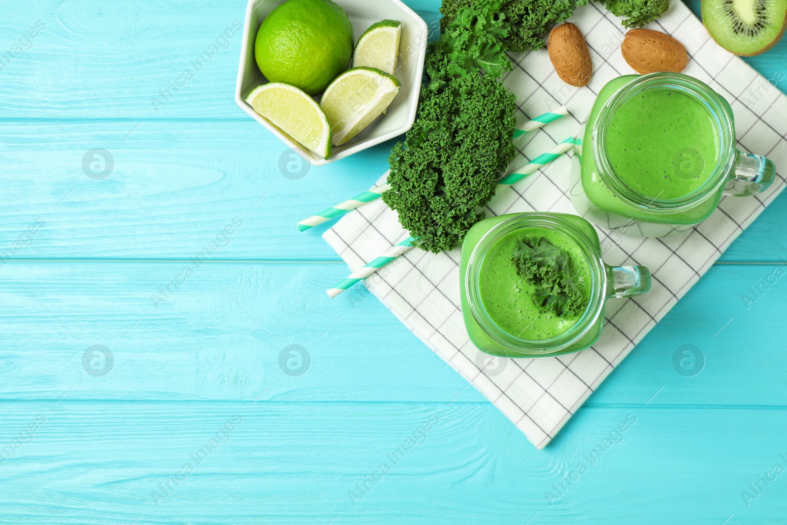 Photo of Flat lay composition with kale smoothie on light blue wooden table, space for text