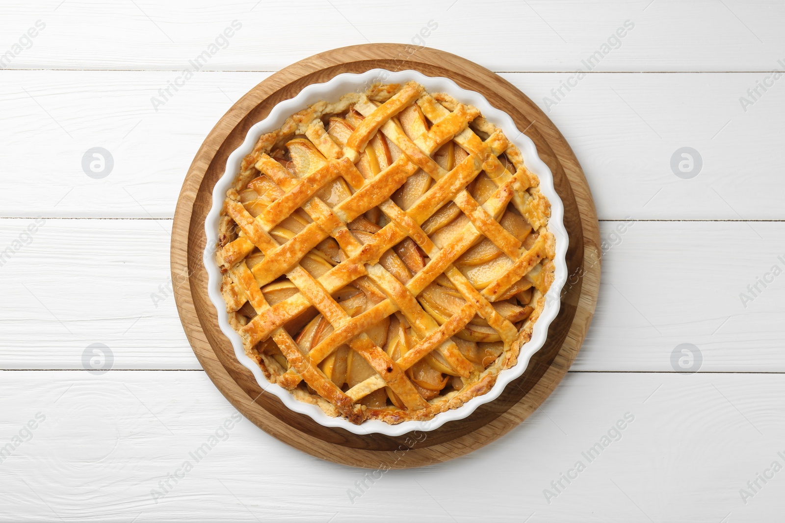 Photo of Tasty homemade quince pie on white wooden table, top view