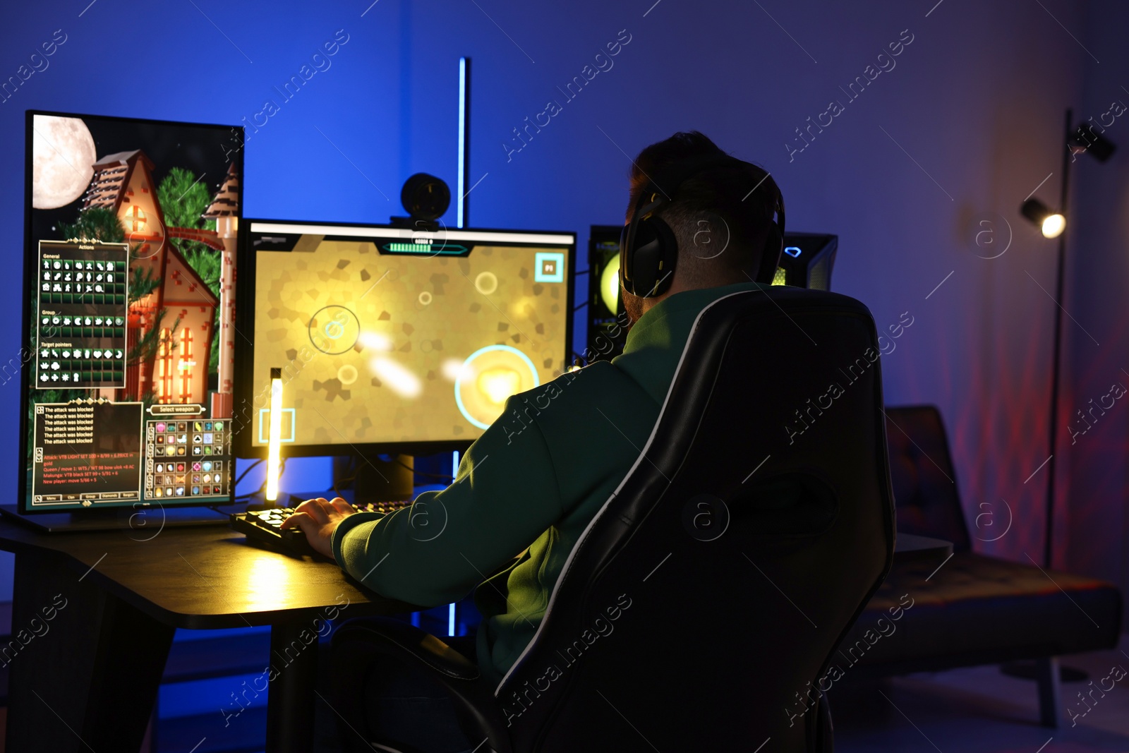 Photo of Man playing video games on computer at table indoors