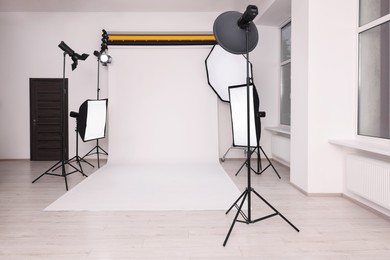 Photo of Stylish photo studio with modern professional equipment