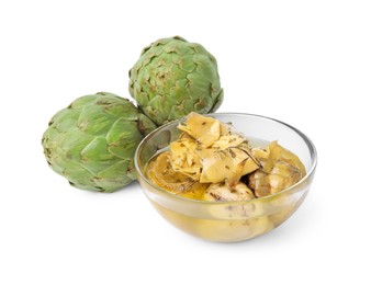 Photo of Bowl with delicious artichokes pickled in olive oil and fresh vegetables on white background