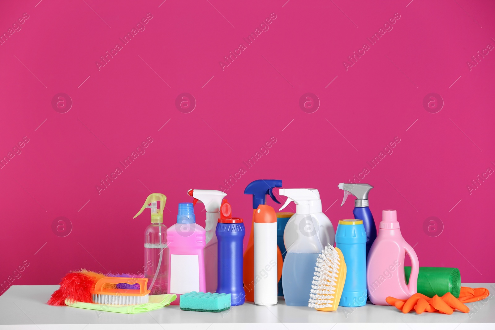 Photo of Cleaning supplies on color background