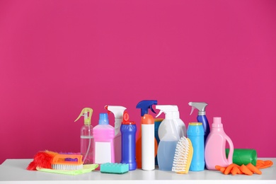 Cleaning supplies on color background