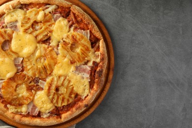 Delicious pineapple pizza on gray table, top view. Space for text