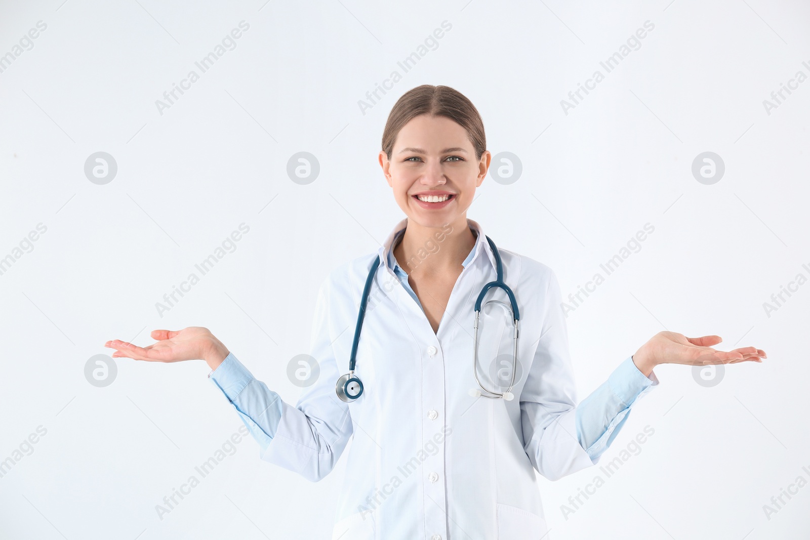 Photo of Portrait of young doctor against white background