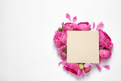 Photo of Fresh peonies and empty card on white background, top view with space for text