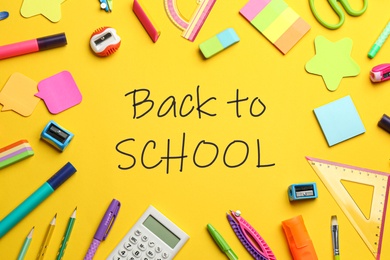 Image of Text Back To School and different stationery on yellow background, flat lay